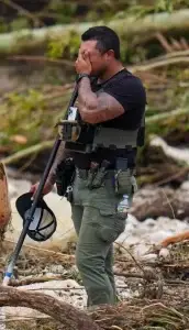 A Sheriffs Deputy takes a moment to process the trauma of a scene in Texas floodings
